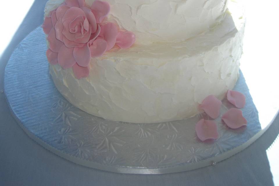 3-tier wedding cake with pink petals