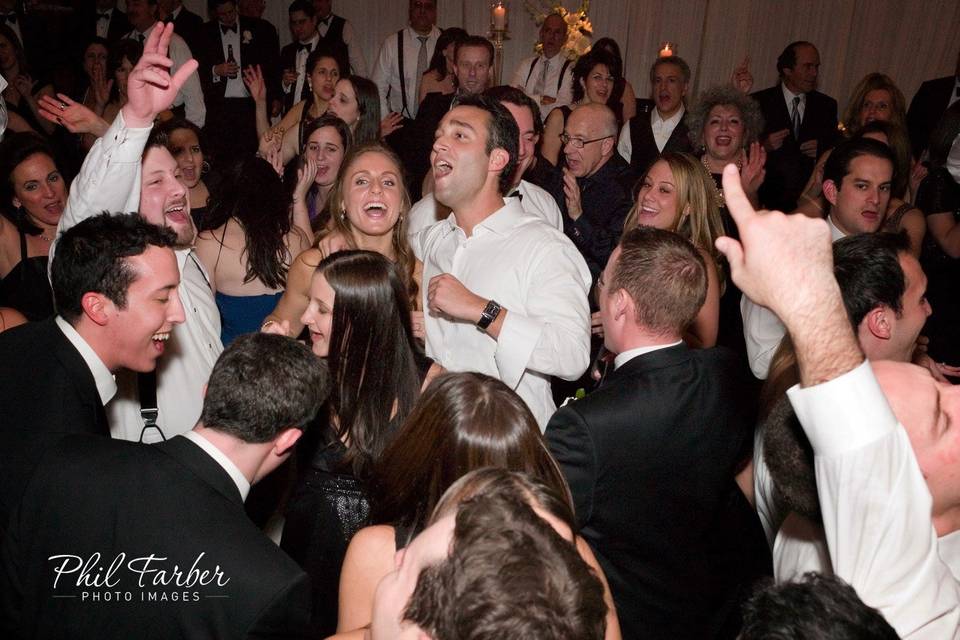 Newlyweds dancing with their guests