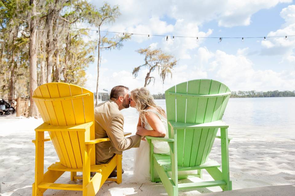 Adirondack chairs on the white sandy shores of paradise cove