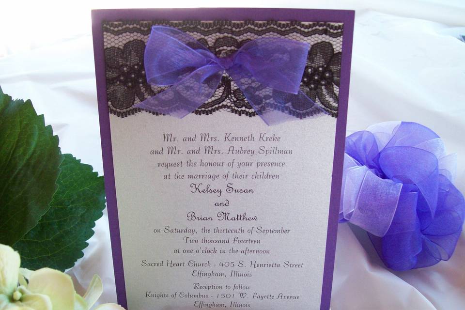 Invitation with a purple backer and white top with black lace