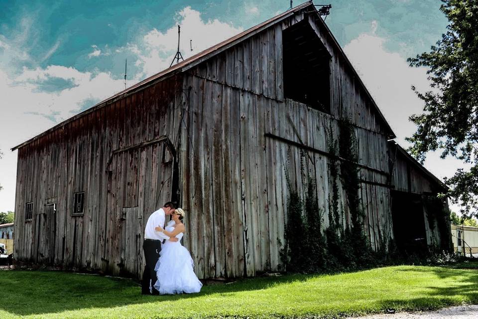 Couple beside a barn
