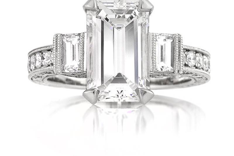 <b>5.49ctw Emerald Cut Diamond Engagement Anniversary Ring</b><br>
This breathtaking emerald cut diamond ring features bright emerald side stones and pave diamonds set on all three sides.