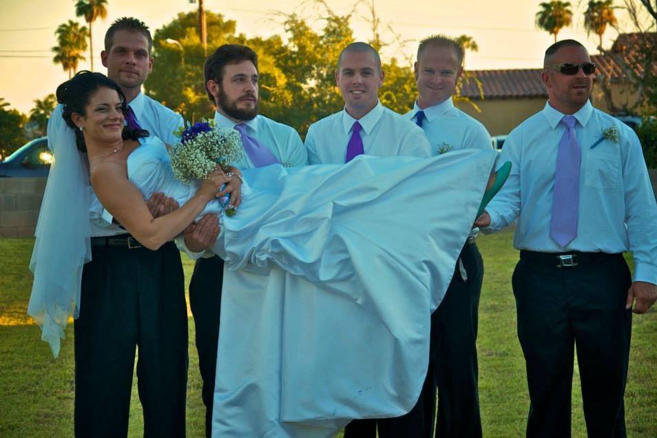 Groomsmen carrying the bride