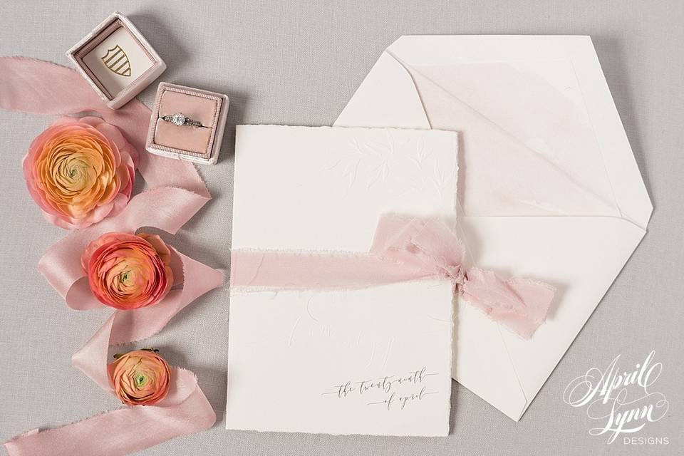 White invitation with pink ribbon