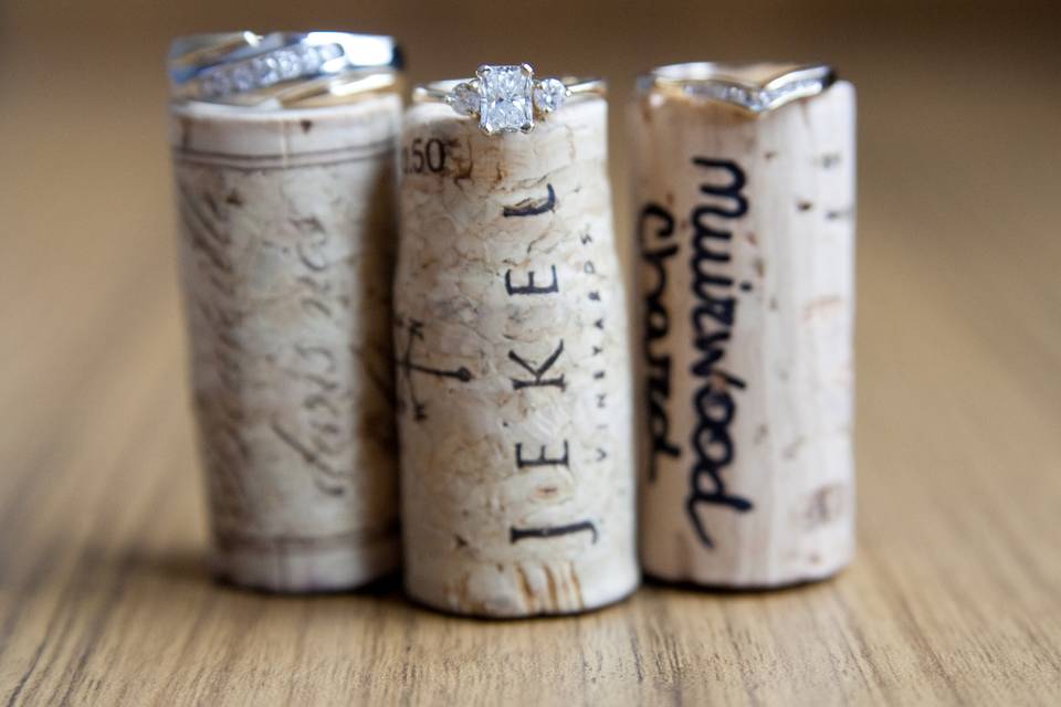 Wedding rings sitting on wine bottle corks