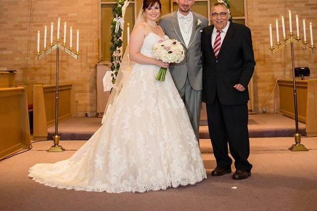The newlyweds and Pastor Fred