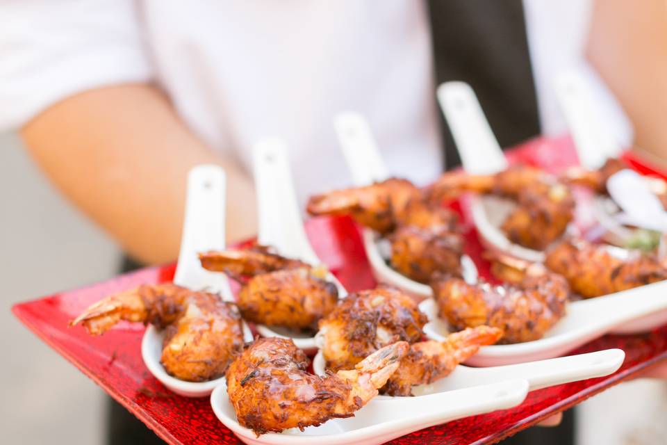 Grilled skewered prawns wrapped in maple cured bacon