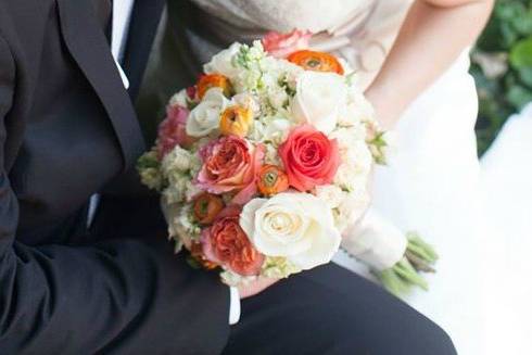 Wedding bouquet including orange, peach and ivory