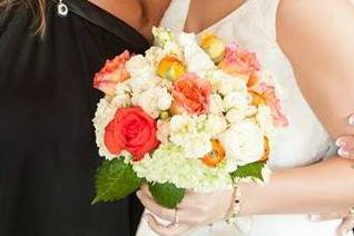 Wedding bouquet including orange, peach and ivory.