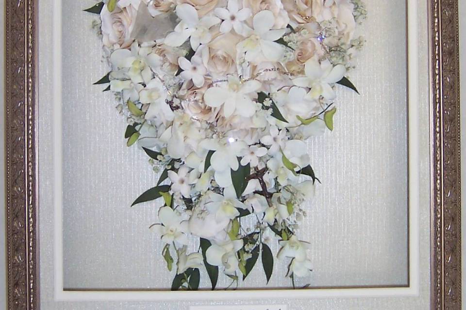 This gorgeous cascading bouquet is showcased in a high-end Larson Juhl frame with personalization.