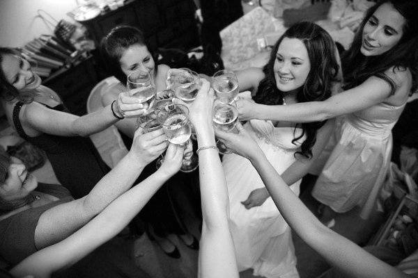 Andrea with her bridesmaids having a toast.