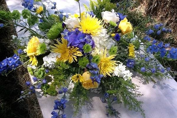 Wedding floral spray of Hydrangea, Spider mums, Roses,Blue Delphinium, Bells of Ireland,  and mixed greens