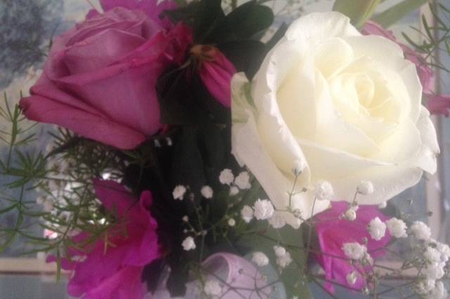 Small romantic bridal bouquet with roses, tulips, azaleas and baby's breath.