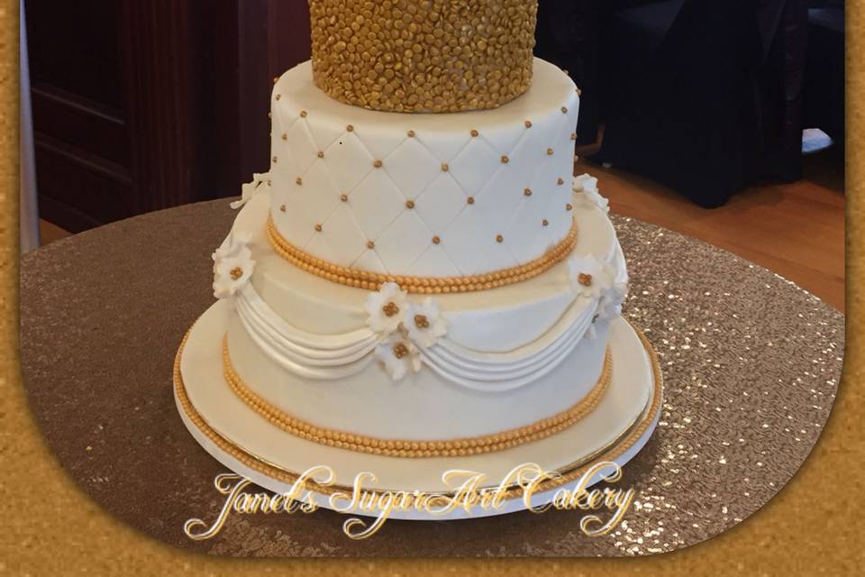 Golden sequins, quilted tuts, and flowery swags bring the theme of this gold and ivory masterpiece together in our delicious Dream Fondant.