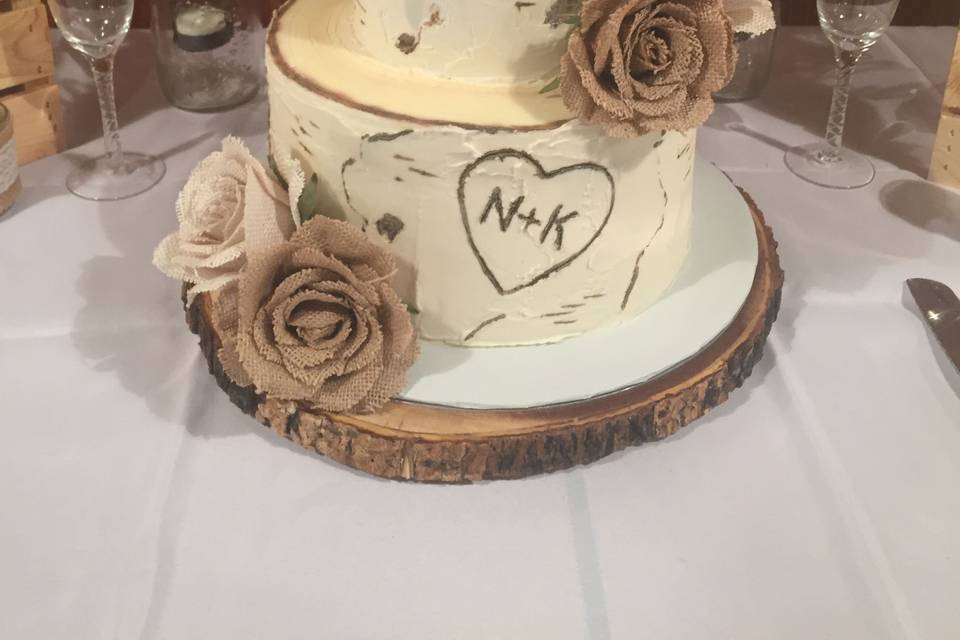 Realistic stacked birch logs in buttercream with burlap roses