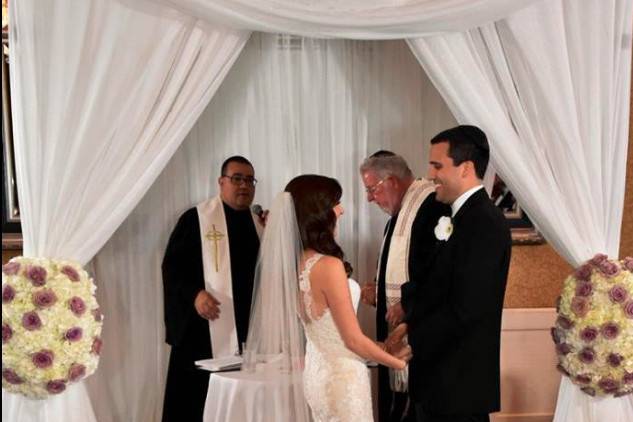 Reverend with the bride and groom