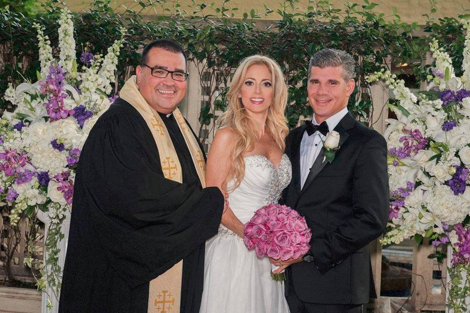 Reverend with the bride and groom