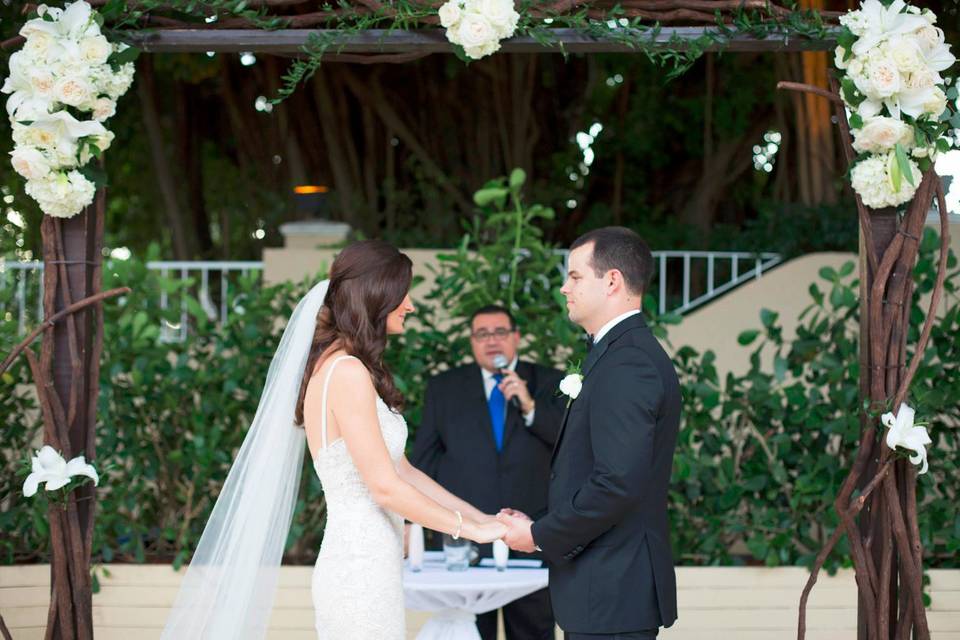 Officiant and the newlyweds in the reception hall