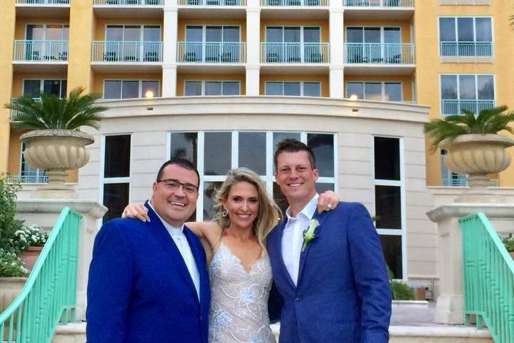 Groom and bride with the officiant