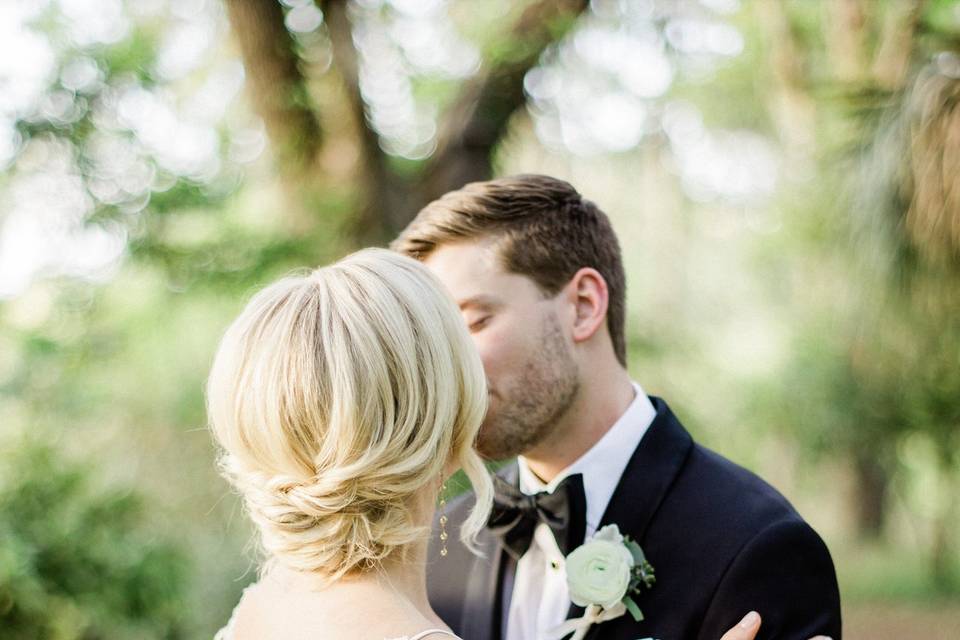 Newlyweds kissing in a forest