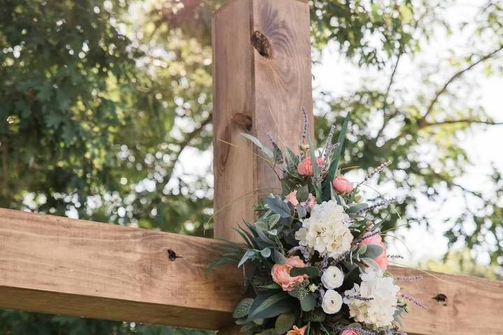 A wooden cross adorned with flowers