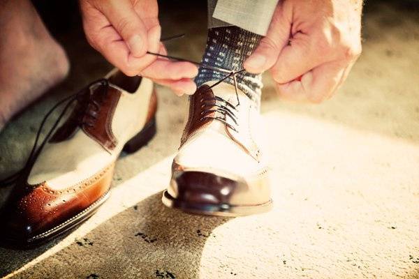 The groom getting dressed by Art Vision Studio