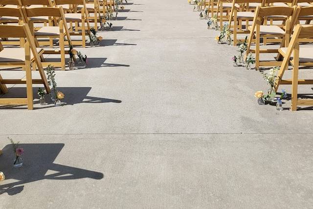 Aisle lined with budvases.