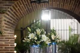 Reception room decorations with tall vase centerpiece strung with Crystals