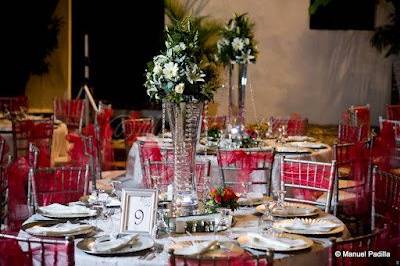Reception decorations with chavarri chairs tied with coral sash