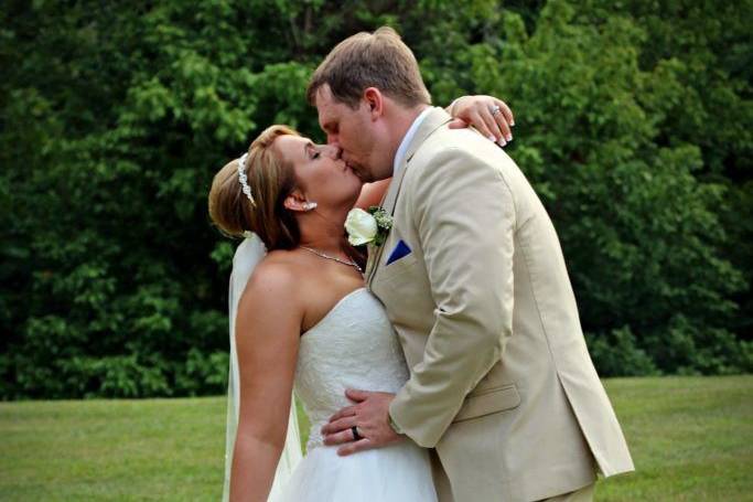 Bride and groom after ceremony photos, first after ceremony kiss