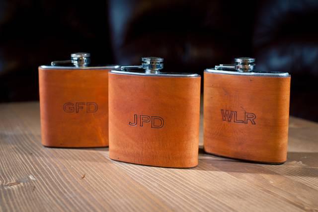 Custom leather wrapped flasks: hand dyed color is saddle tan hand sewn in the back