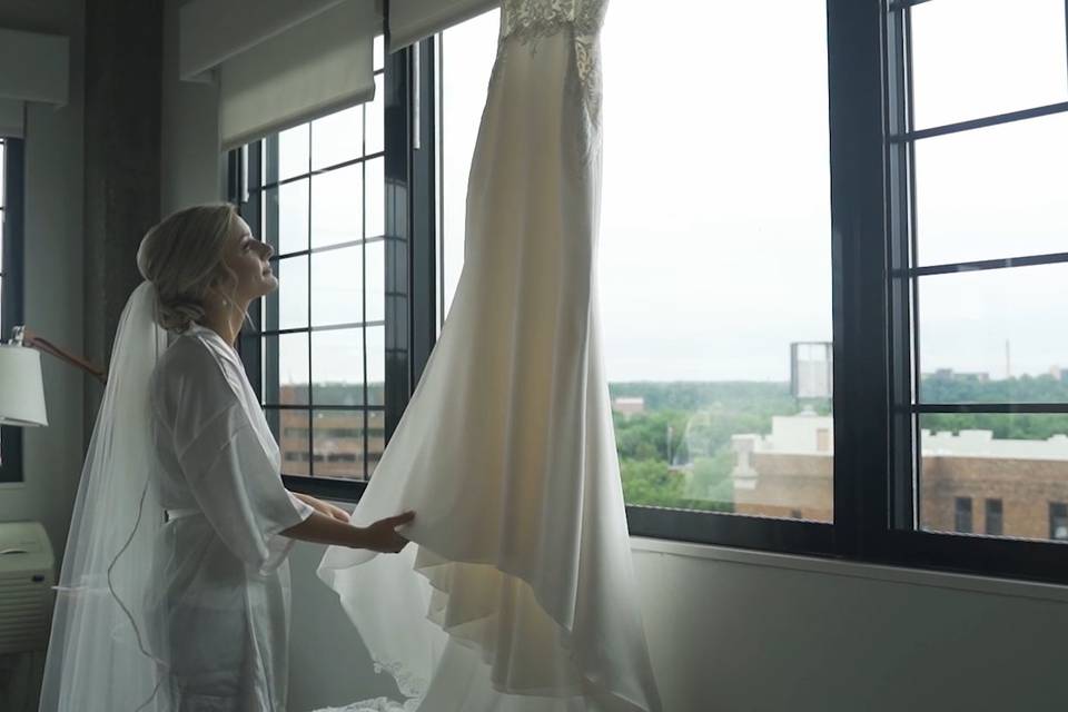Bride admiring dress