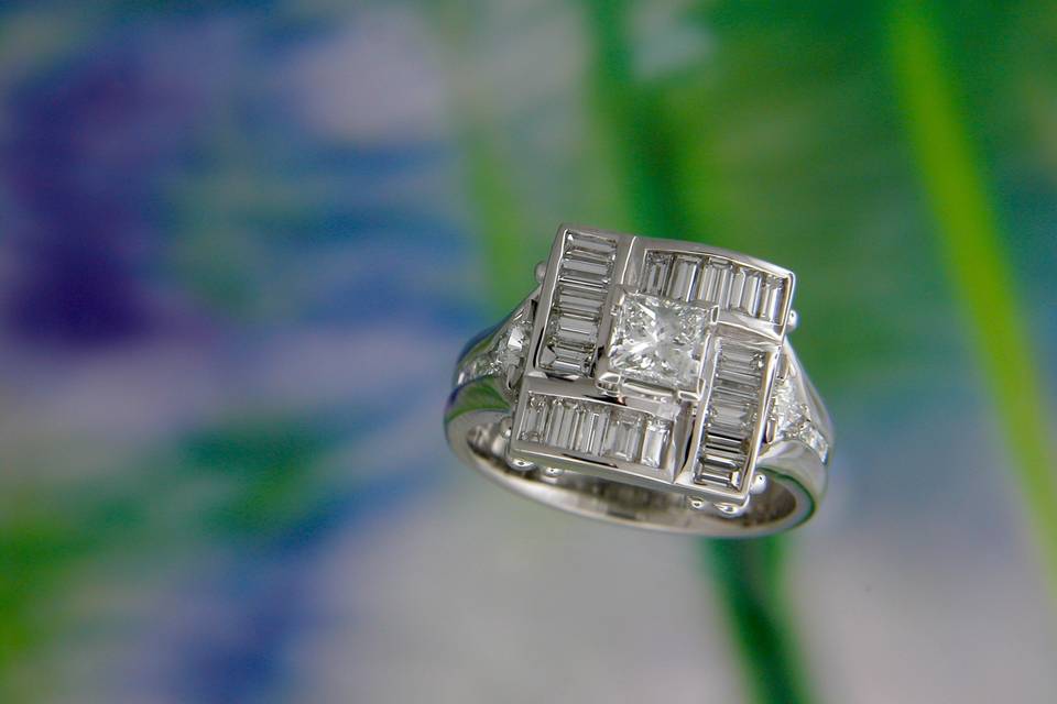 Top view of finished wedding ring with three-quarter carat princess cut center, surrounded by a unique square halo comprised of four arched sections... One of a kind!