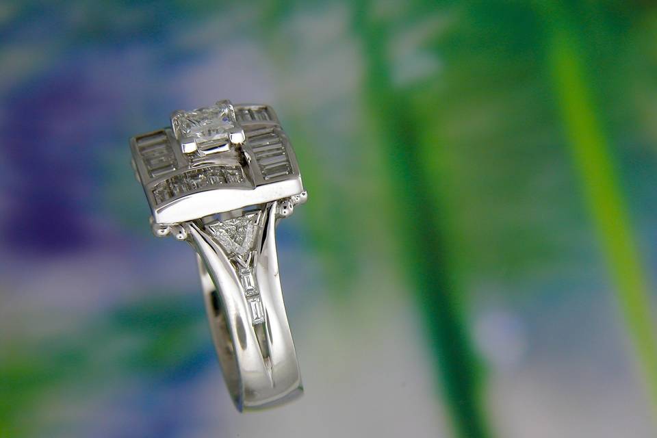 Side view of finished wedding ring showing the arched nature of the square halo with trilliant and channel set baguette cut diamonds.