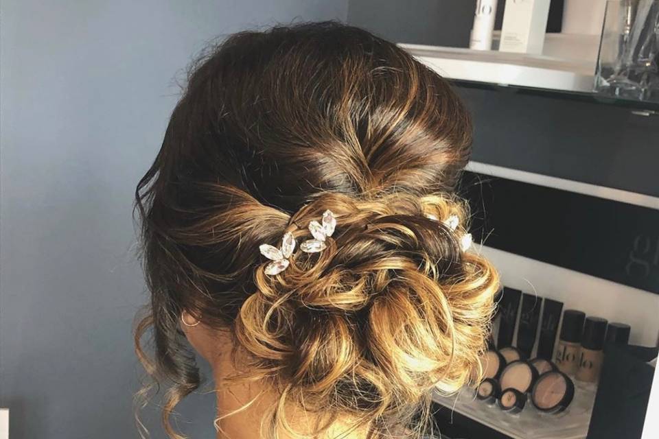 Classic updo with styled tendrils