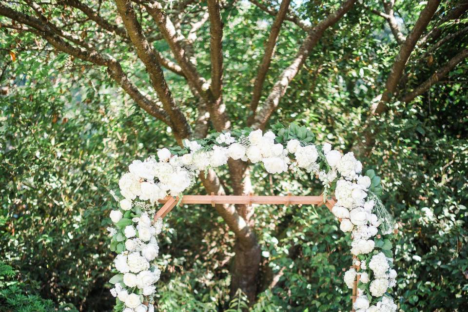 Wedding arch decorated in white flowers