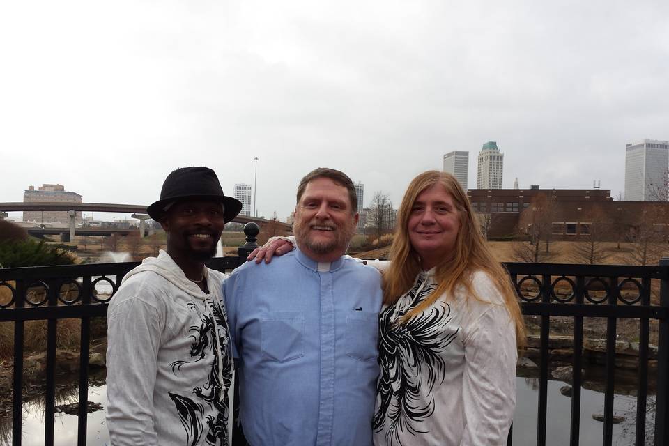 Donna and Rashid pose with Rev Bob after their wedding in Centennial Park in Tulsa, OK