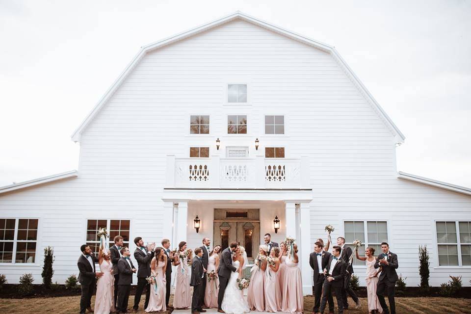 The couple with the bridesmaids and groomsme