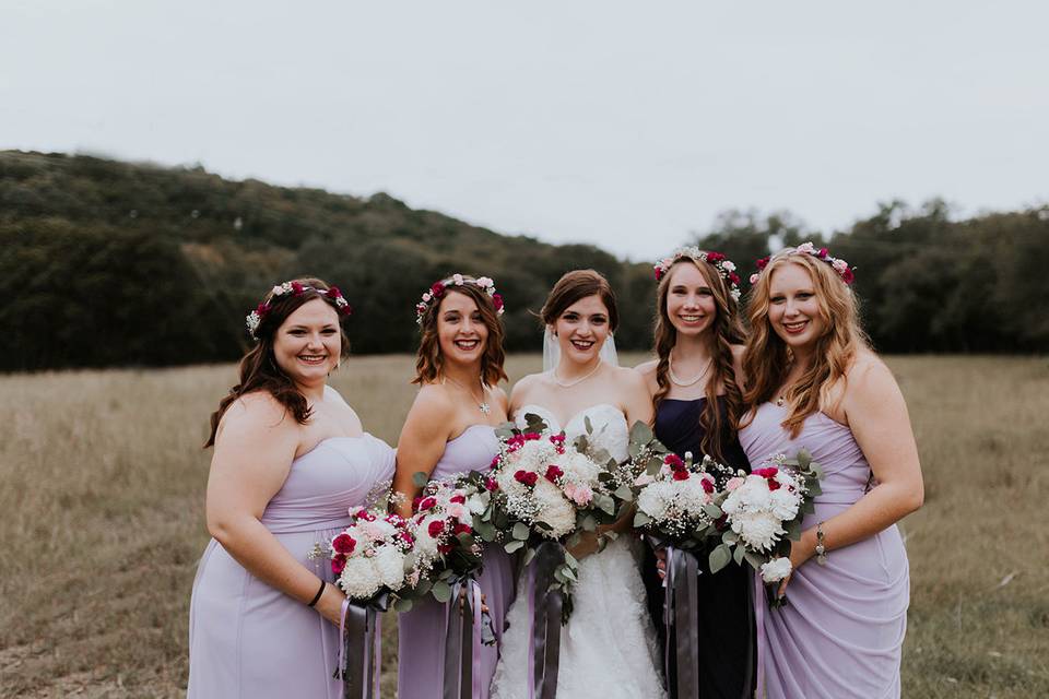Bridesmaids with bouquets and flower crowns.