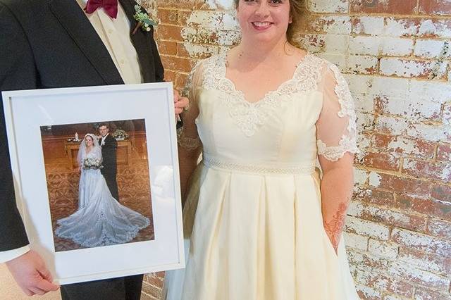 Restyled vintage gown. Groom is holding picture of the  dress as it was, originally. Photo by Little House Studio