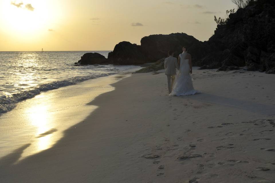 Newlyweds walk by the shore