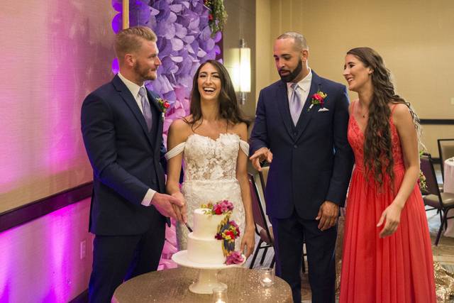 Joyful couple | Photography: Nicholas Woolsey Photography www.nicholaswoolseyphoto.comVenue: Holiday Inn Virginia Beach-Norfolk Hotel and Conference Center http://hiexeccenter.com/Linens/Napkins: Waterford Event Rentals http://waterfordeventrentals.com/Backdrop: Katherine Hallberg Designs https://www.katherinehallbergdesign.com/ Lighting: Stage Right Lighting http://www.srlweddings.com/Wedding Officiant: Reverend Ken Lane  http://revkenlane.comVideography: Indigo Harbour 3 https://www.facebook.com/IndigoHarbor3/ Cakes/Desserts: Candies Treats and More http://candiestreats.com/ Flowers/Centerpieces: TcTc Unforgettable Weddings & Event https://www.tctcparties.com/contactBridal Gown Company: Truly Yours Bridal https://www.trulyyoursbridal.comMen’s Tuxedos: Mens Warehouse https://www.menswearhouse.comMakeup: Cristal Clear Artistry http://www.cristalclearartistry.comTransportation: Lavish Limos www.lavishlimosva.com
