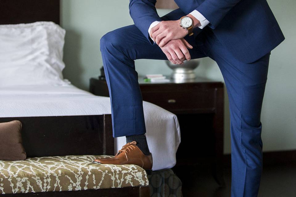 Groom posing | Photography: Nicholas Woolsey Photography www.nicholaswoolseyphoto.comVenue: Holiday Inn Virginia Beach-Norfolk Hotel and Conference Center http://hiexeccenter.com/Linens/Napkins: Waterford Event Rentals http://waterfordeventrentals.com/Backdrop: Katherine Hallberg Designs https://www.katherinehallbergdesign.com/ Lighting: Stage Right Lighting http://www.srlweddings.com/Wedding Officiant: Reverend Ken Lane  http://revkenlane.comVideography: Indigo Harbour 3 https://www.facebook.com/IndigoHarbor3/ Cakes/Desserts: Candies Treats and More http://candiestreats.com/ Flowers/Centerpieces: TcTc Unforgettable Weddings & Event https://www.tctcparties.com/contactBridal Gown Company: Truly Yours Bridal https://www.trulyyoursbridal.comMen’s Tuxedos: Mens Warehouse https://www.menswearhouse.comMakeup: Cristal Clear Artistry http://www.cristalclearartistry.comTransportation: Lavish Limos www.lavishlimosva.com