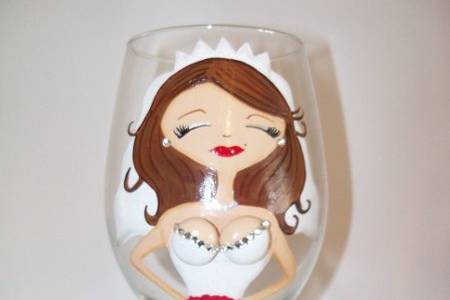 The blushing bride. This bride glass has brown hair, white dress, red lips and her flowers are red. Rhinestones on the busts. With a custom saying on the back with the date of the wedding. Make it personalize with your hair color, style and length. Mrs. ....... on the back and the date. Your flower and dress color and it's all custom just for you on your special day!Brides are $35