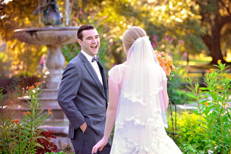 Newlyweds beside fountain