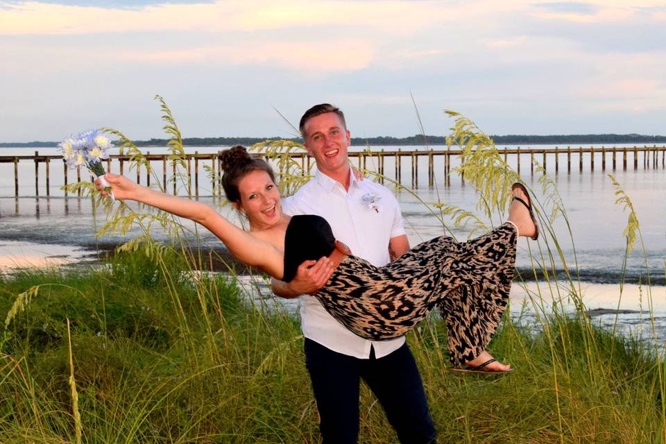 Groom carrying his bride