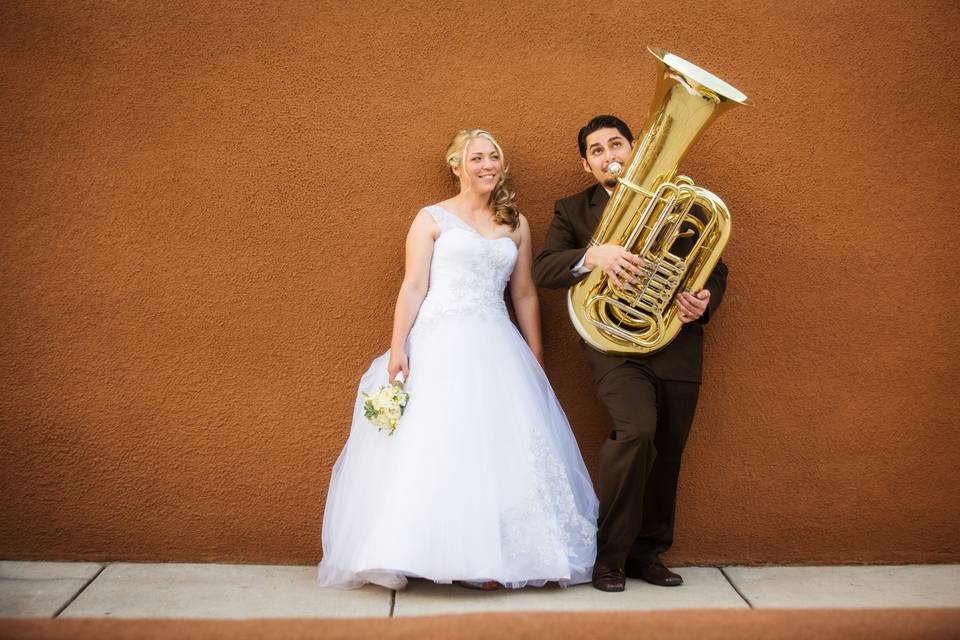 The bride presented the groom with a tuba for a wedding gift. Here he is playing a few notes for the bride.