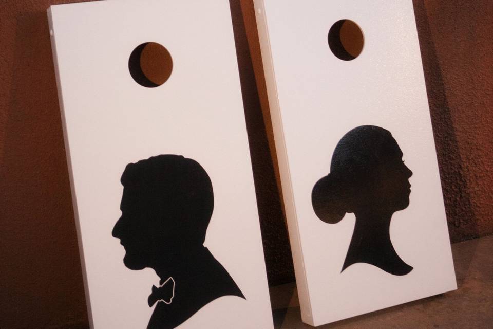 The couple had corn hole and checkers along with a photo booth set up for guests to enjoy themselves. These had the couples silhouettes added.