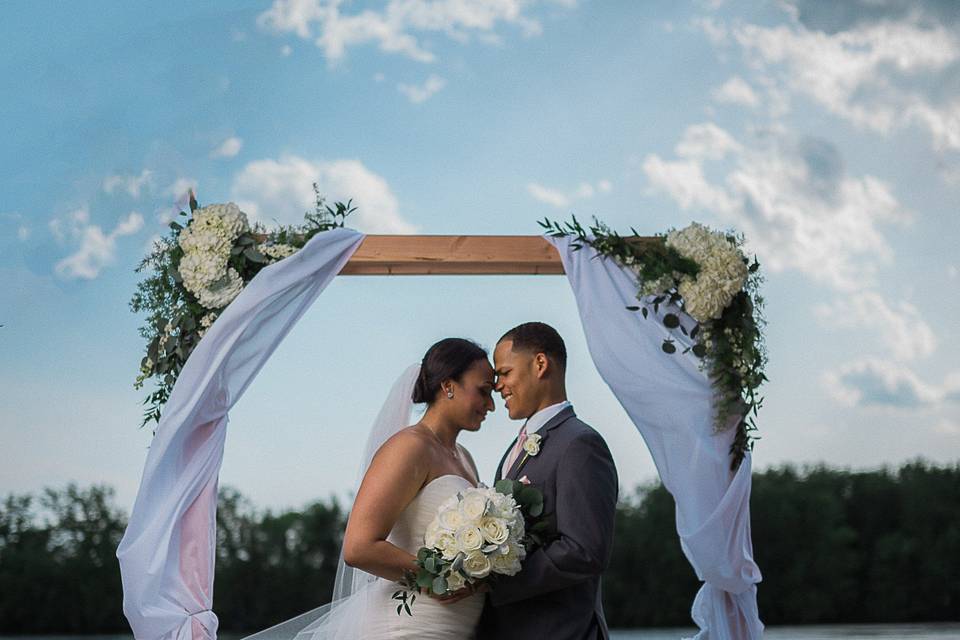 Couple in wedding arbor