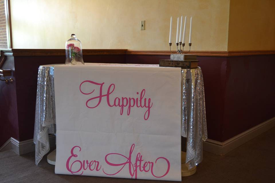 Happily Ever After! Some décor at the entrance of the fun yet classic Beauty and the Beast themed wedding reception.